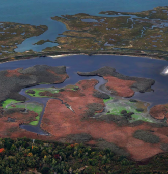 An aerial view of colored wetlands on Plum Island by the Parker River National Wildlife Refuge.