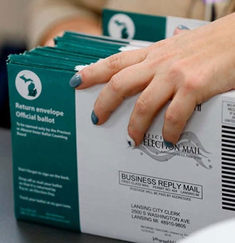 Workers start pre-processing absentee ballots at the city of Lansing Clerk’s Election Unit on November 2, 2020 in Lansing, Michigan Photo: Jeff Kowalsky (Getty Images)
