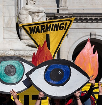 Climate activists hold signs at a protest in Washington on the day after Election Day. (Eric Lee/Bloomberg)