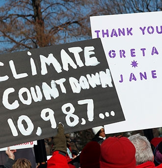 Activist signs during the "Fire Drill Fridays" climate change protest and rally outside on Capital Hill on December 20, 2019 in Washington, DC. Photo by Paul Morigi/Getty Images