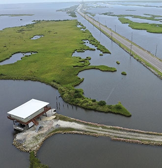 A home on stilts sits amid coastal waters and marshlands along Louisiana Highway 1 on Aug. 24, 2019, in Grand Isle, Louisiana. Drew Angerer / Getty Images