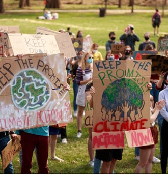 Protesters hold placards during the Keep the Promise rally