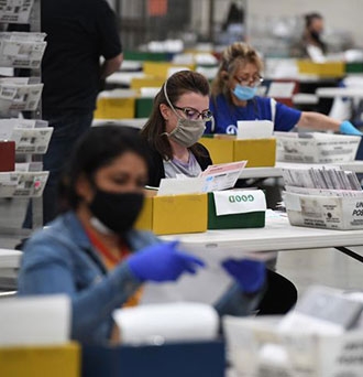 LA County Election workers process mail-in ballots - Robyn Beck via Getty Images