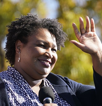 Stacey Abrams speaks to Biden supporters on Nov. 2, 2020, at Turner Field in Atlanta. Credit: Brynn Anderson/AP