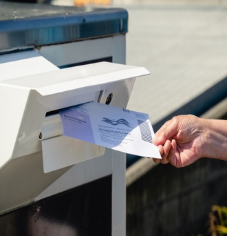 Voter returning a mail ballot