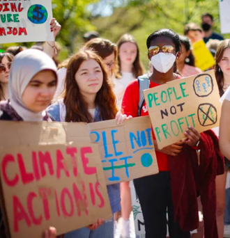 Young climate activists stage rally in Lafayette Park across from the White House on Earth Day on April 22, 2022, in Washington, D.C. Organized by Fridays for Future DC, about 50 young people gathered to protest against the use of fossil fuels.