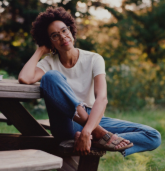 Dr Ayana Elizabeth Johnson on a picnic bench.